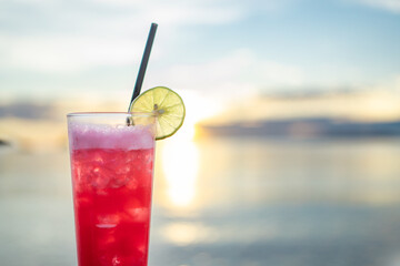 Summer Vacation Concept : Fruit cocktail glass. Welcome drink put on wooden table nearly the sea.