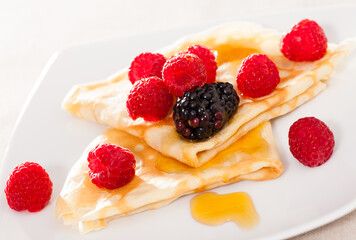 pancakes with raspberries, blackberries and honey