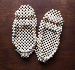 Slippers made of wooden balls. Natural physiotherapy for flat feet. Prevention against flatfoot