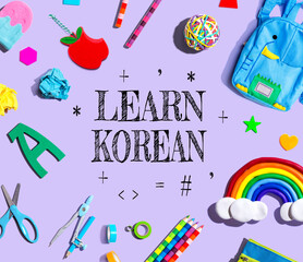 Learn Korean theme with school supplies on a purple background