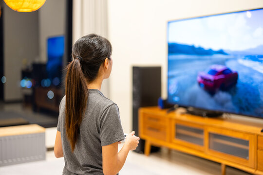 Woman play TV video game at home