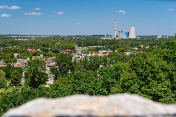 Fototapeta na wymiar Castle in Bedzin, a view from the top of the castle tower to the vast urban landscape. Summer sunny day.