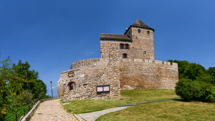 Fototapeta na wymiar Castle in Bedzin, a castle situated on a slope, is an example of defensive construction from the 14th century. Front view of the castle on a sunny summer day.