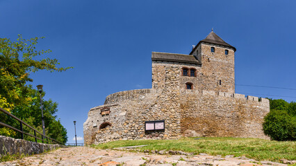 Fototapeta na wymiar Castle in Bedzin, a castle situated on a slope, is an example of defensive construction from the 14th century. Front view of the castle on a sunny summer day.