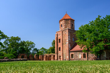 Fototapeta premium Castle in Toszek, a brick castle from the 15th century, partially reconstructed. View from the green courtyard to the building.