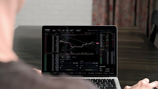 Ethereum and cryptocurrency volatility. Young woman sits at laptop at home and watches Ethereum trading. Exchange, rise and fall chart, finance business concept. Trader, stock exchange, online trading