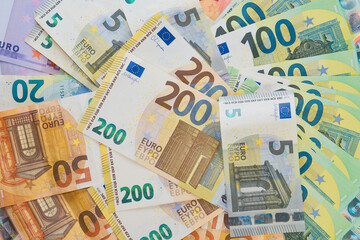 Pile of paper euro banknotes as part of the payment system of one country or countries of the European Union. Top view of euro banknotes
