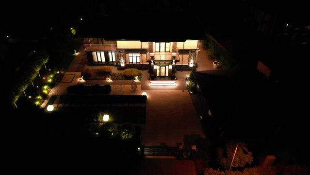 Night illumination of a country house from a drone