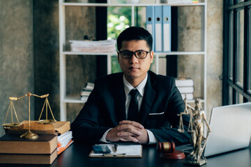 Lawyer businessman working or reading law report in office workplace for consultant lawyer concept.