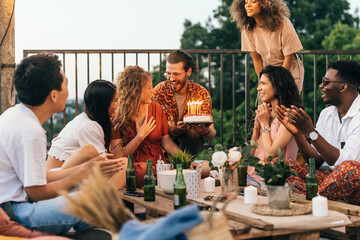 A birthday girl celebrates with her friends at the rooftop party.