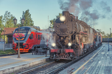 Fototapeta na wymiar Steam locomotives stand by the wooden platform.