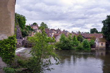 Fototapeta na wymiar View of the river Sarthe in Fresnay-sur-Sarthe on a cloudy spring afternoon, France