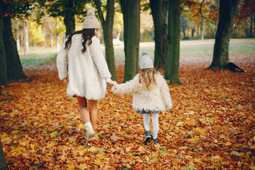 Cute and stylish family in a autumn park