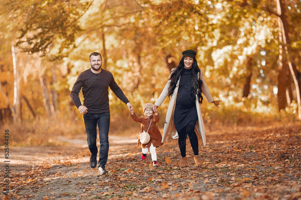 Wall mural family with little daughter in a autumn park