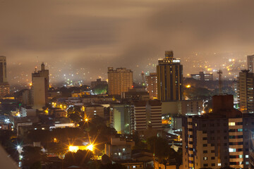 Obraz premium Border town Iguassu Falls in fog at night, Brazil
