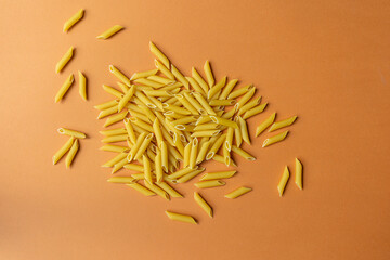 raw pasta on a yellow background close-up, space for a slogan