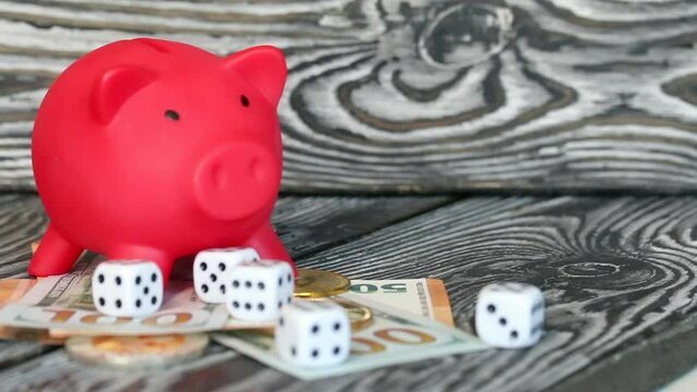 Piggy bank among dollar and euro banknotes. Cryptocurrency coins are visible. Multicurrency savings. Risk while saving money. Slider camera