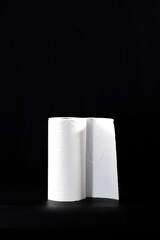 Close-up of a paper towel roll, on a black background