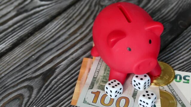 Piggy bank among dollar and euro banknotes. Cryptocurrency coins are visible. Multicurrency savings. Risk while saving money. Taken from above.