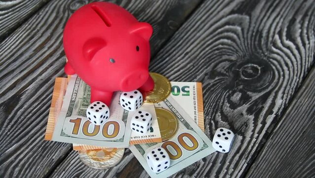 Piggy bank on dollar and euro banknotes. Cryptocurrency coins and dice. Multicurrency savings. Difficulties in saving money.
