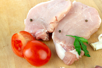 Raw meat. Raw fillet of stuck with garlic, tomato, spice, pepper, champignon, close up.
