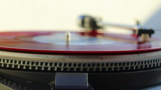 old Red vinyl record with clipping path. DJ Turntable with Vinyl Record, Playing, Top View. Close up at the needle on turntable	
