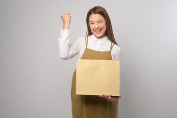 Portrait of young asian woman wearing apron over white background studio, cooking and entrepreneur...