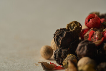 Details of a mountain of colored pepper on a white background