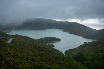 Blue crater lake with Atlantic ocean in the distance