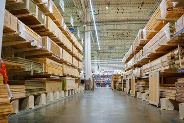 racks with wooden boards and slabs in the warehouse of the hardware store. 