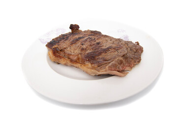 Grilled beef fillet, on a plate, isolated in white background. Most red meat fillets consumed in the world are beef (ox, bull, cow or veal).