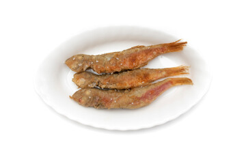 Fried red mullet, on a plate, isolated on white background. Spanish food concept.