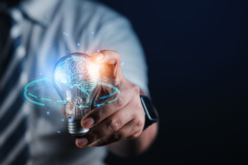 businessman holding light bulb and brain graphic inside It represents the imagination of business networking technology innovation.	
