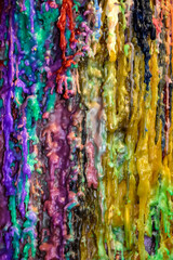 Abstract multicolored background of streaks of wax candles. Stripes of different colors. Close-up. Selective focus.