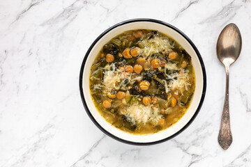 Chicory and chickpea soup with Parmesan (zuppa di ceci e cicoria con parmigiano). Italian cuisine.