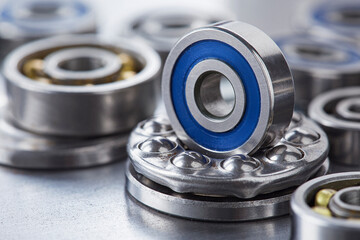 different bearings, vernier caliper and ruler on metal background. Part of mechanism.