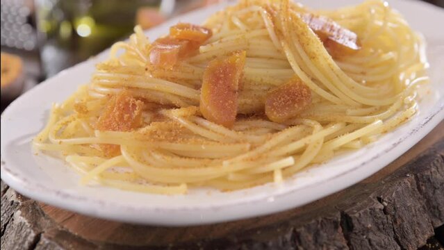 Spaghetti with bottarga. Typical Sardinian Cuisine. A dish with traditional Italian pasta from the South, dried sardine roe, lemon and pasta. High quality 4k footage