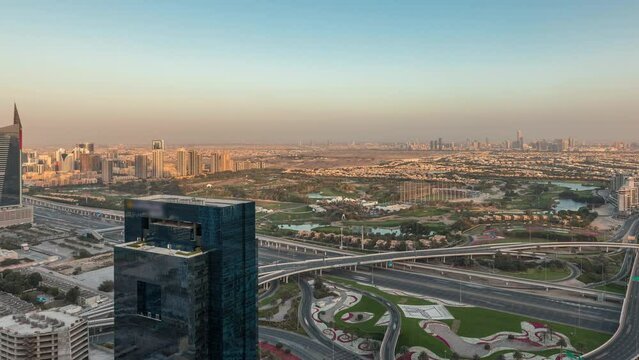 Panorama showing Dubai marina and JLT skyscrapers along Sheikh Zayed Road with huge junction near golf course and media city district aerial timelapse. Residential and office buildings from above.