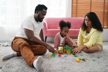 Fototapeta premium Shot of happy interracial family of mother father and their daughter inside modern apartment.