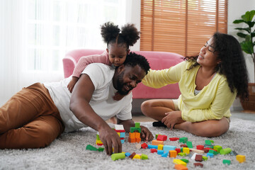 Obraz premium Shot of happy interracial family of mother father and their daughter inside modern apartment.