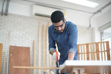 Carpenter or warehouse worker choosing raw wood material for the work at the carpentry storage
