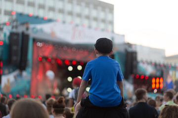 A concert on the street in the city with a large number of people.