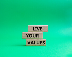 Live your values symbol. Concept words 'Live your values' on wooden blocks. Beautiful green background. Business and Live your values concept. Copy space.