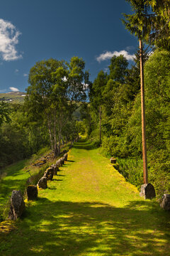 A hiking trail on the historic mesmerizing Vindhellavegen with several switchbacks / hairpin bends through the beautiful green hills of Borgund, Laerdal, Norway