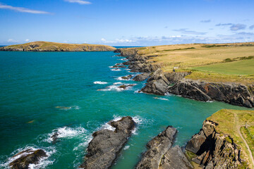 Low altitude aerial view of the rugged Welsh coastline in Pembrokeshire (Gwbert)
