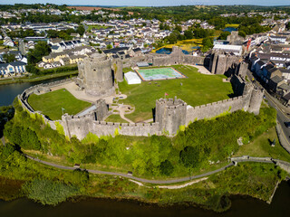 Aerial view of the ruins of a large, ancient castle in Wales (Pembroke Castle)