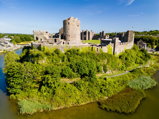 Aerial view of the ruins of a large, ancient castle in Wales (Pembroke Castle)