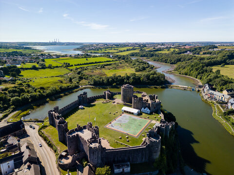 Aerial view of the ruins of a large, ancient castle in Wales (Pembroke Castle)