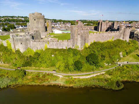 Aerial view of the ruins of a large, ancient castle in Wales (Pembroke Castle)