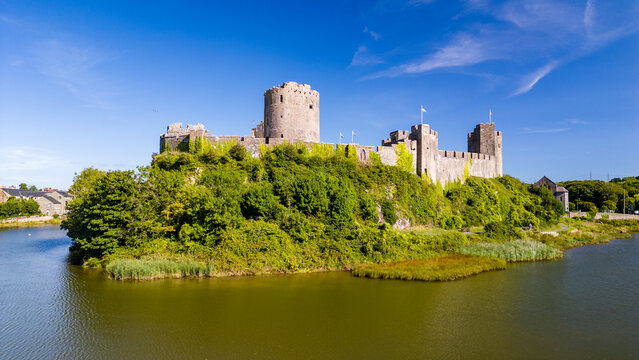 Aerial view of the ruins of a large, ancient castle in Wales (Pembroke Castle)